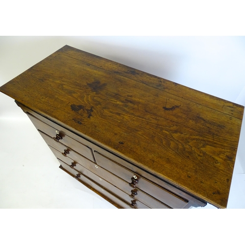 1381 - An 18thC oak chest of drawers with a rectangular top above two short over three long graduated drawe... 