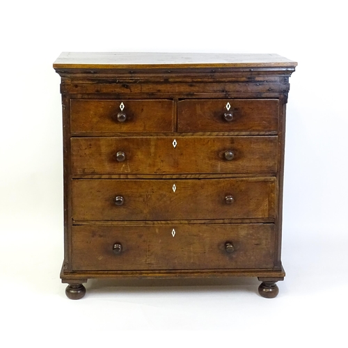 1381 - An 18thC oak chest of drawers with a rectangular top above two short over three long graduated drawe... 