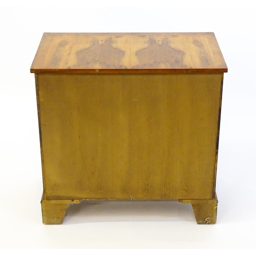 1384 - A yew wood veneered chest of drawers, with a rectangular crossbanded top above two short over three ... 