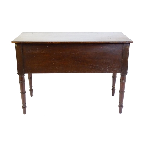 1387 - An early 19thC mahogany desk with a reeded edge above a single long drawer and two short drawers and... 