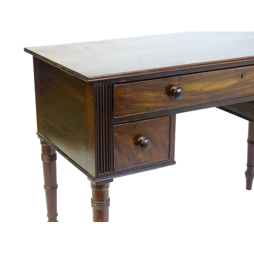 1387 - An early 19thC mahogany desk with a reeded edge above a single long drawer and two short drawers and... 