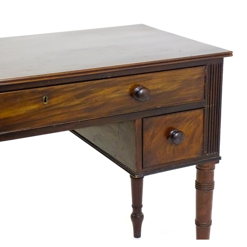 1387 - An early 19thC mahogany desk with a reeded edge above a single long drawer and two short drawers and... 