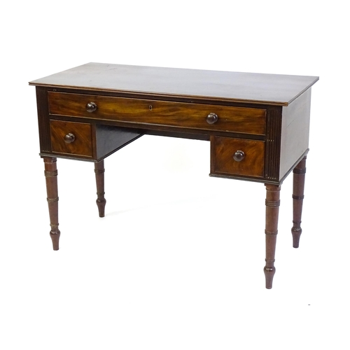 1387 - An early 19thC mahogany desk with a reeded edge above a single long drawer and two short drawers and... 