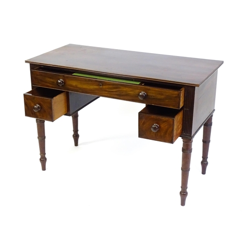 1387 - An early 19thC mahogany desk with a reeded edge above a single long drawer and two short drawers and... 