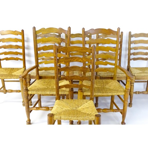 1392 - A group of eight mid 20thC oak dining chairs, with ladderbacks, envelope rush seats and raised on ta... 