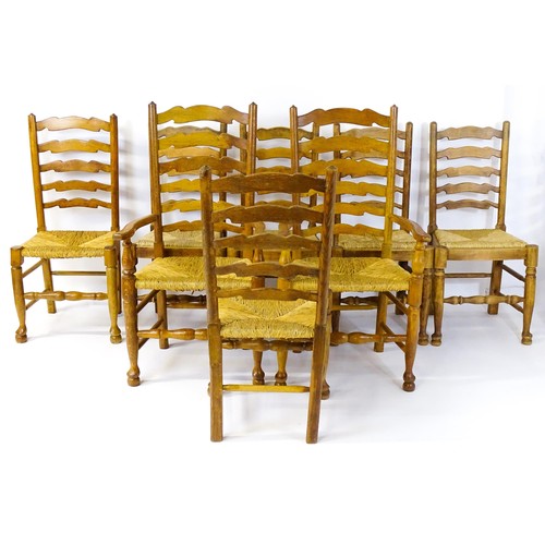 1392 - A group of eight mid 20thC oak dining chairs, with ladderbacks, envelope rush seats and raised on ta... 