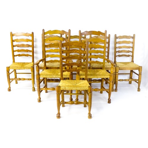 1392 - A group of eight mid 20thC oak dining chairs, with ladderbacks, envelope rush seats and raised on ta... 