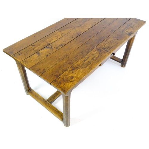 1397 - An 18thC and later refectory style table / desk with a planked top above a small frieze drawer, the ... 