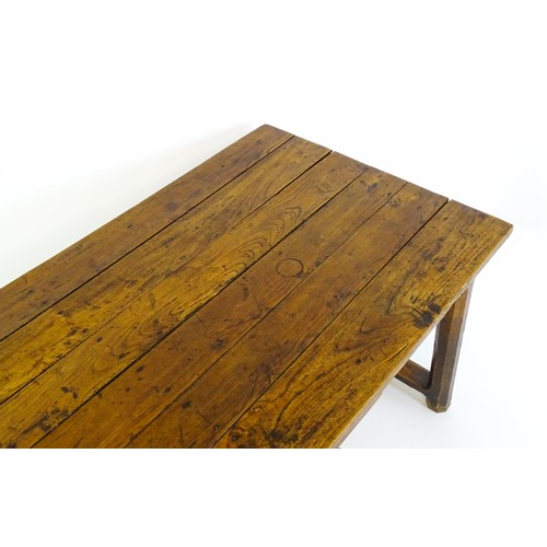 1397 - An 18thC and later refectory style table / desk with a planked top above a small frieze drawer, the ... 