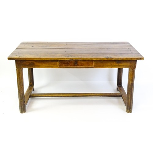 1397 - An 18thC and later refectory style table / desk with a planked top above a small frieze drawer, the ... 