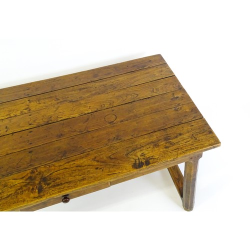 1397 - An 18thC and later refectory style table / desk with a planked top above a small frieze drawer, the ... 