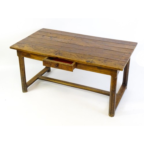 1397 - An 18thC and later refectory style table / desk with a planked top above a small frieze drawer, the ... 