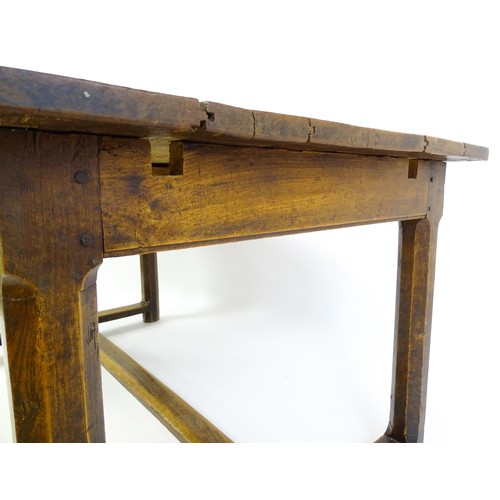 1397 - An 18thC and later refectory style table / desk with a planked top above a small frieze drawer, the ... 