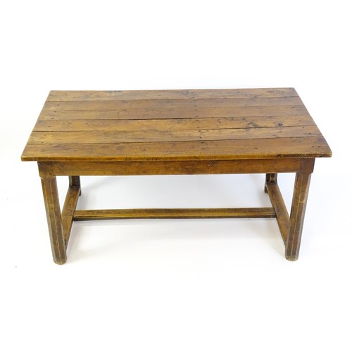 1397 - An 18thC and later refectory style table / desk with a planked top above a small frieze drawer, the ... 