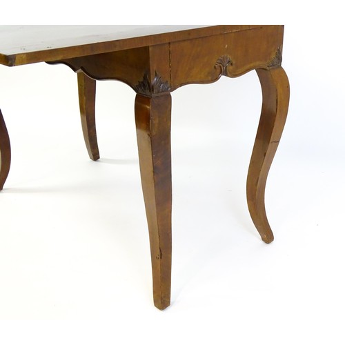 1399 - An early 20thC mahogany tea table of large proportions, the hinged rectangular top above a shell car... 