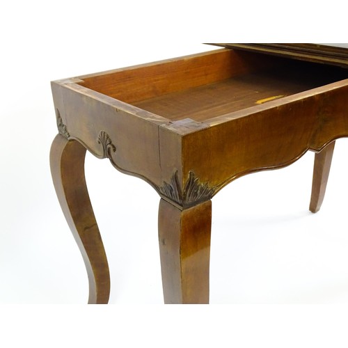 1399 - An early 20thC mahogany tea table of large proportions, the hinged rectangular top above a shell car... 