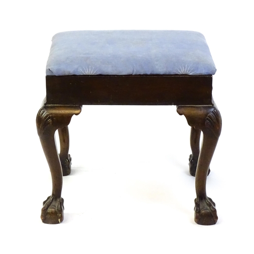 1401 - An early 20thC mahogany piano stool with an upholstered, hinged top above four cabriole legs with ac... 