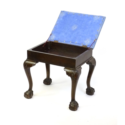 1401 - An early 20thC mahogany piano stool with an upholstered, hinged top above four cabriole legs with ac... 