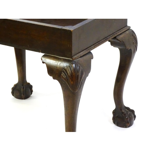 1401 - An early 20thC mahogany piano stool with an upholstered, hinged top above four cabriole legs with ac... 