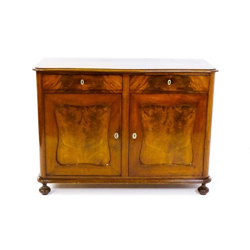 1403 - A late 19thC / early 20thC mahogany sideboard, with a serpentine fronted thumb moulded top above two... 