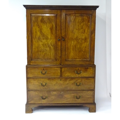 1404 - A mid to late 18thC mahogany linen press with dentil moulded cornice, two well figured panelled door... 