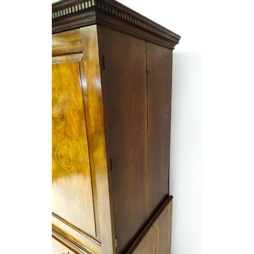 1404 - A mid to late 18thC mahogany linen press with dentil moulded cornice, two well figured panelled door... 