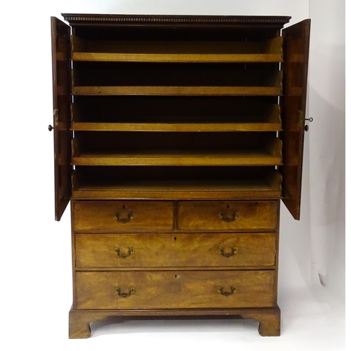 1404 - A mid to late 18thC mahogany linen press with dentil moulded cornice, two well figured panelled door... 