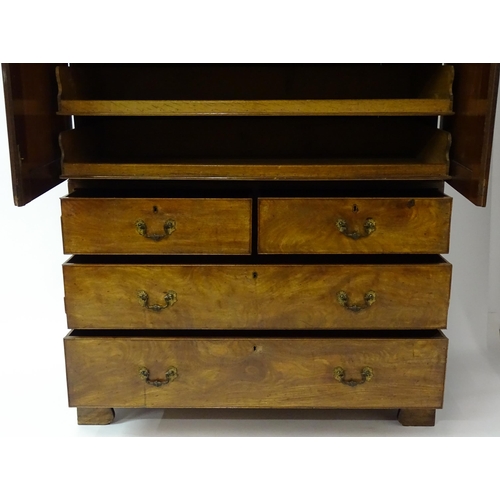 1404 - A mid to late 18thC mahogany linen press with dentil moulded cornice, two well figured panelled door... 