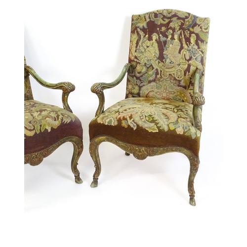 1406 - A pair of 20thC open armchairs, with shaped top rails, shaped arms with carved and scrolled decorati... 