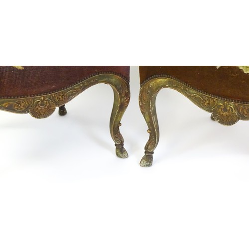 1406 - A pair of 20thC open armchairs, with shaped top rails, shaped arms with carved and scrolled decorati... 