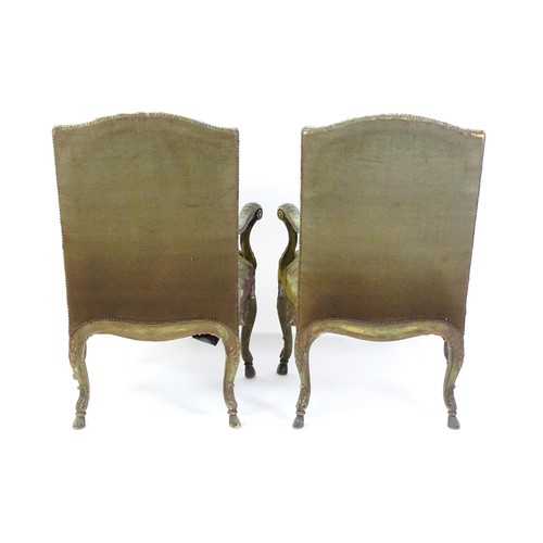 1406 - A pair of 20thC open armchairs, with shaped top rails, shaped arms with carved and scrolled decorati... 