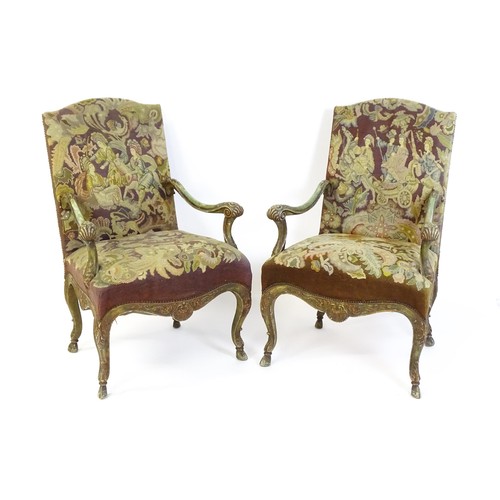 1406 - A pair of 20thC open armchairs, with shaped top rails, shaped arms with carved and scrolled decorati... 