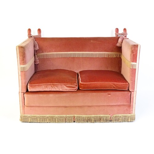 1410 - An 20thC Knole sofa with, two drop arms, donkey ear supports and rope tassels. Measuring 55