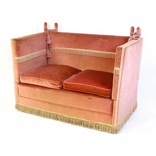 1410 - An 20thC Knole sofa with, two drop arms, donkey ear supports and rope tassels. Measuring 55