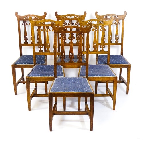 1411 - A set of six oak Arts & Crafts dining chairs with shaped, pierced top rails and floral back splats r... 