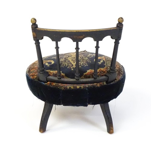 1413 - A late 19thC nursing chair with a bowed top rail surmounted by turned finials, turned back splats an... 