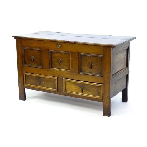 1415 - A late 17thC oak mule chest with a hinged lid above three faux drawers and two short drawers above s... 