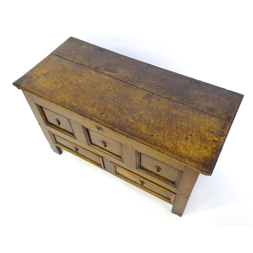 1415 - A late 17thC oak mule chest with a hinged lid above three faux drawers and two short drawers above s... 