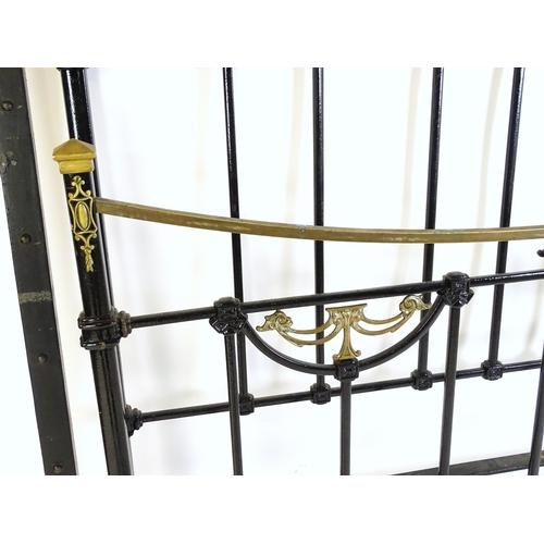 1421 - A 19thC painted iron bed with gilt highlights. Measuring 54