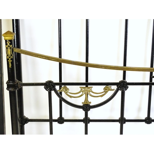 1421 - A 19thC painted iron bed with gilt highlights. Measuring 54