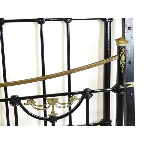 1421 - A 19thC painted iron bed with gilt highlights. Measuring 54