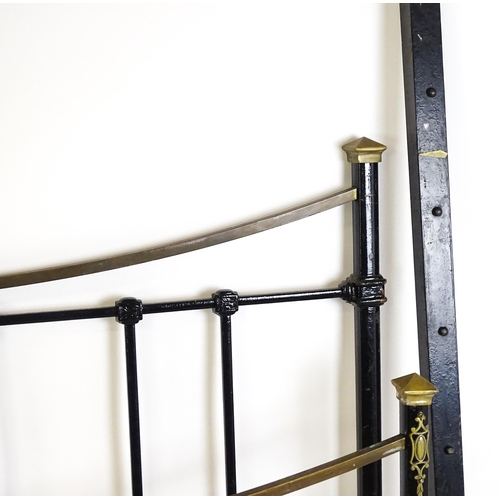 1421 - A 19thC painted iron bed with gilt highlights. Measuring 54