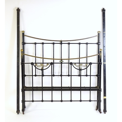 1421 - A 19thC painted iron bed with gilt highlights. Measuring 54