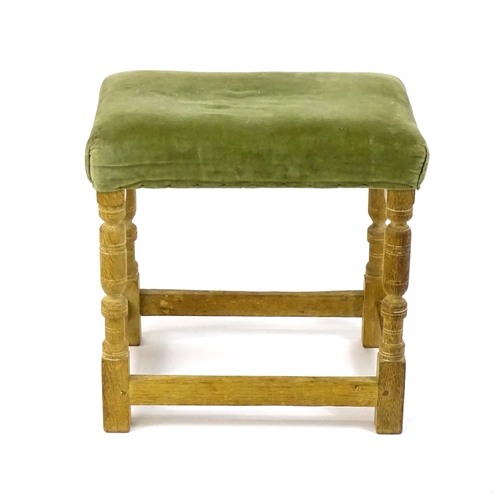 1424 - An early / mid 20thC limed oak 'Hamptons' stool with a rectangular upholstered top above four turned... 