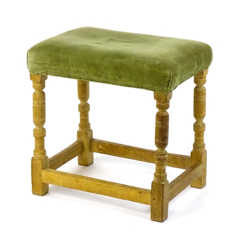 1424 - An early / mid 20thC limed oak 'Hamptons' stool with a rectangular upholstered top above four turned... 