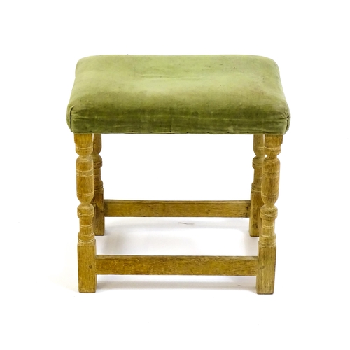 1424 - An early / mid 20thC limed oak 'Hamptons' stool with a rectangular upholstered top above four turned... 