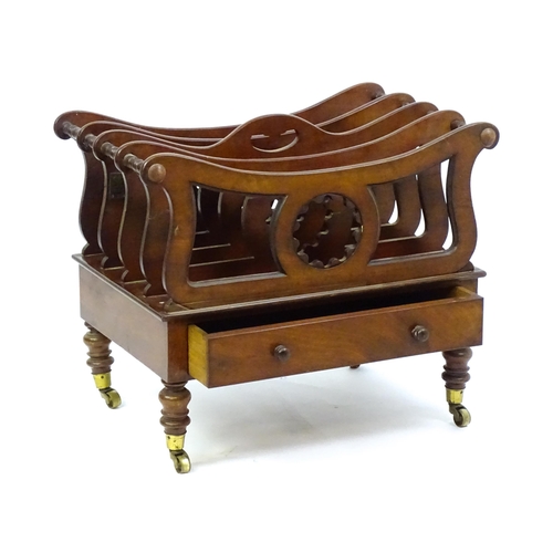 1427 - A mid 19thC mahogany Canterbury with a pierced handle, four sections with bowed top rails and pierce... 