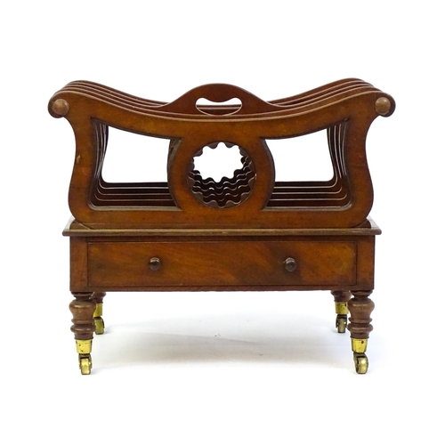 1427 - A mid 19thC mahogany Canterbury with a pierced handle, four sections with bowed top rails and pierce... 