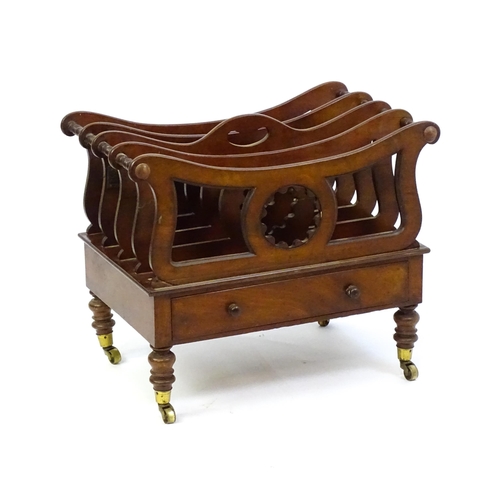 1427 - A mid 19thC mahogany Canterbury with a pierced handle, four sections with bowed top rails and pierce... 