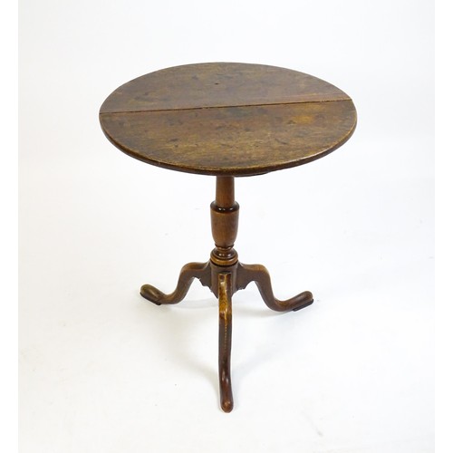 1429 - A late 18thC oak tripod table with a circular top above a tapering turned pedestal and three cabriol... 